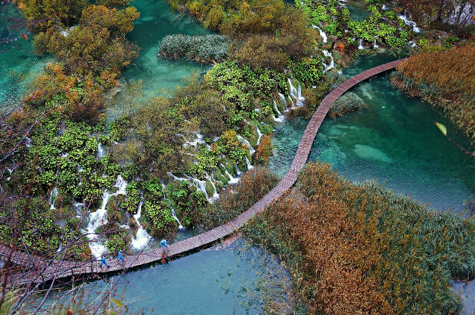 brown wooden dock on waterfalls