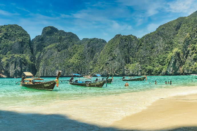 people riding on boat on beach during daytime