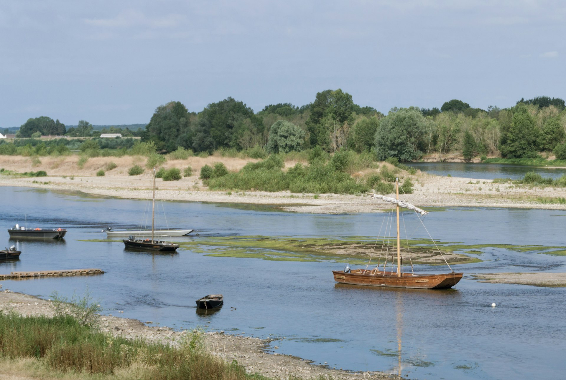 a group of boats floating on top of a river