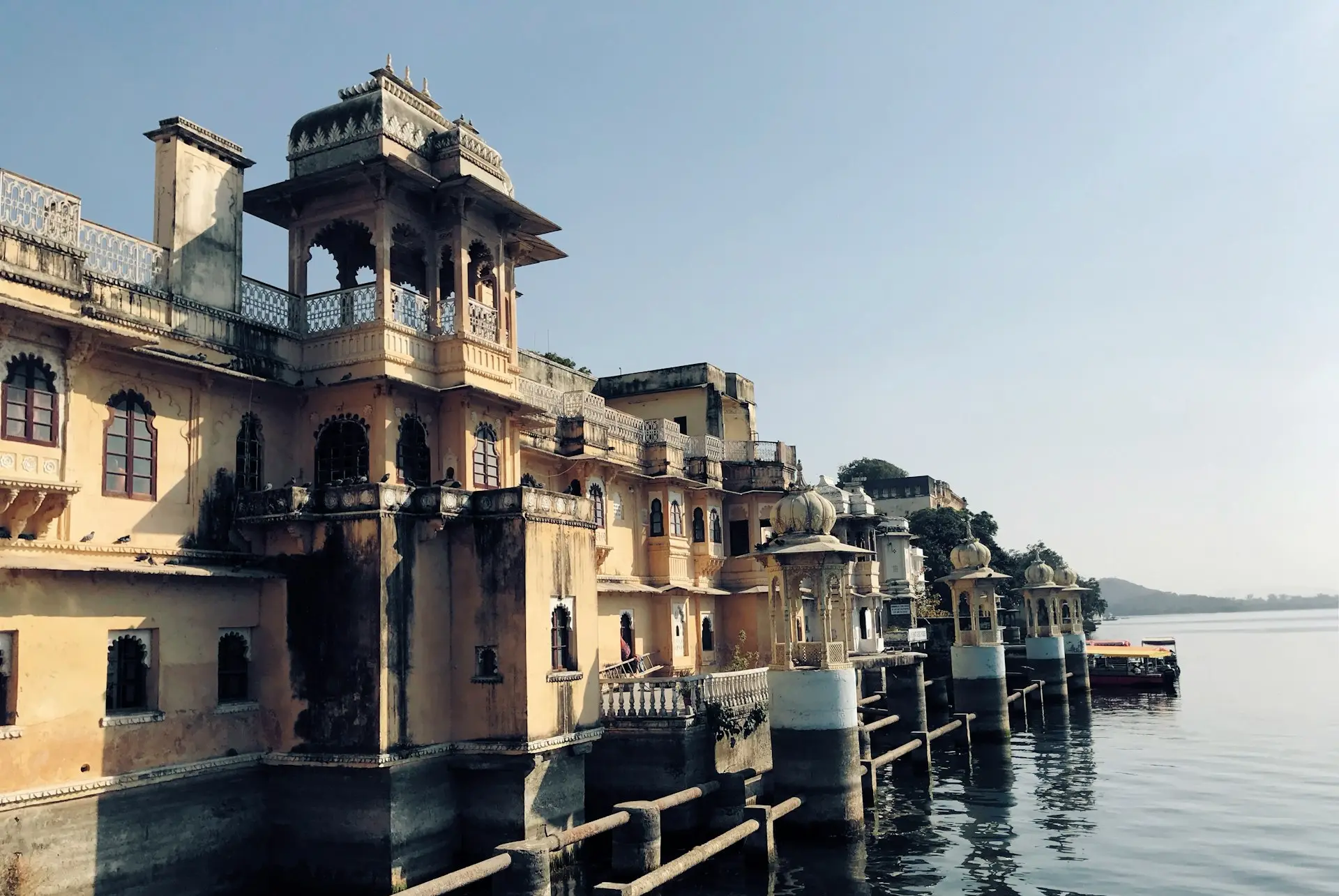 yellow painted buildings near body of water view during daytime